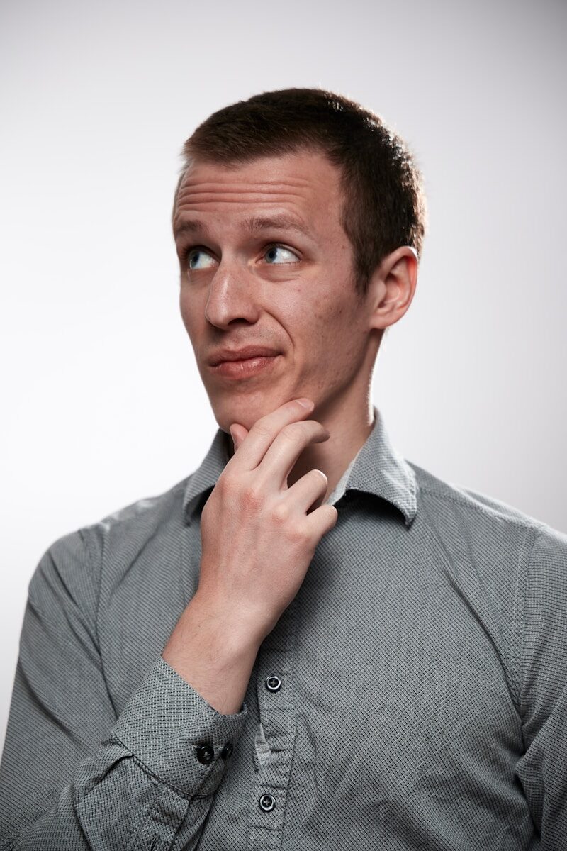 Photo by Ludovic Migneault man in gray button up shirt